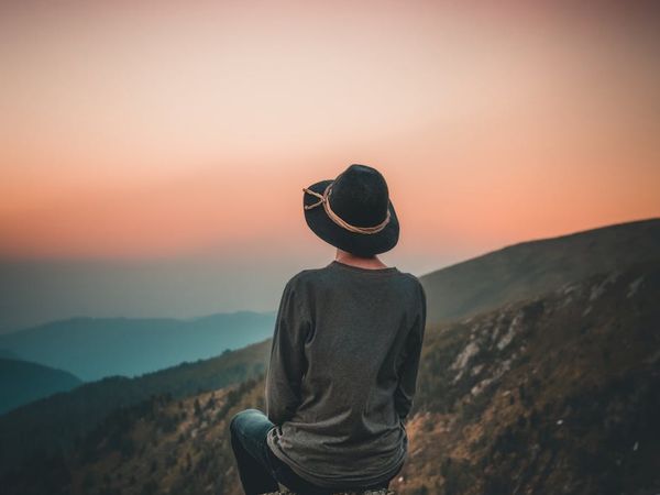 A person sitting in a peaceful meditation pose outdoors.